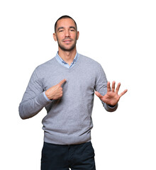 Friendly young man doing a gesture of keep calm