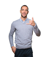 Happy young man making a gesture of calling with the hand