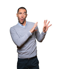 Scared young man screaming against background