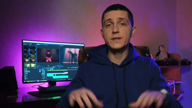 Young man youtuber filming tutorial video in home studio. Online learning. Videographer talks about video editing
