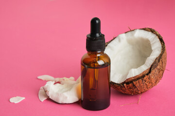 Natural organic coconut oil or serum in amber glass dropper bottle