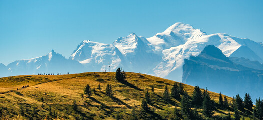 Hikers with a view of Mont Blanc from La Bourgeoise near Samoens in Haute-Savoie