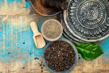 Indian spices collection, dried black peppercorns and another spices in clay bowls
