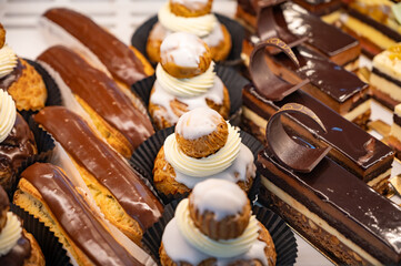 Assortment of french fresh baked sweet pastry with fresh fruits and berries in confectionery shop