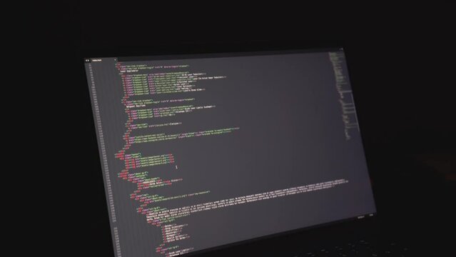 hacker: hacker who writes code. man working on laptop in night light
