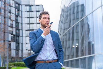 Professional corporate man businessman outside the office sending a voice memo