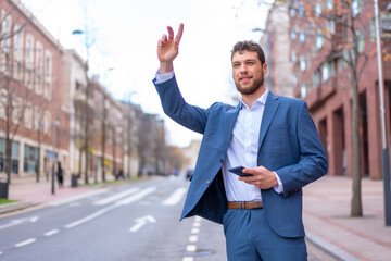 Businessman or finance man calling a taxi to go to work at the office in the city