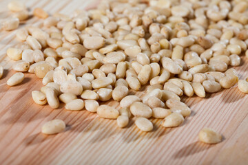 Pile of delicious pine nuts on a wooden surface. High quality photo