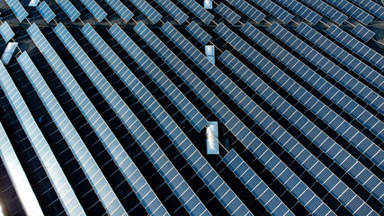Large solar panel array on rooftop top down aerial view