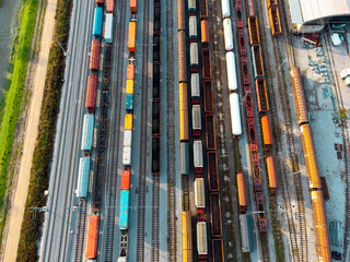 Above the railway tracks with cargo cars on the tracks aerial view