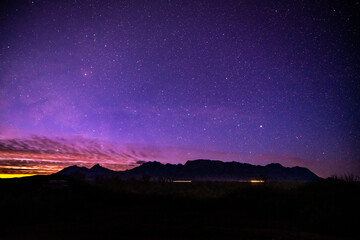 Sunlight and Car Lights Below Night Sky