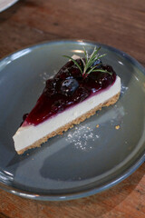 Blueberry Cheesecake. Whole fresh berries inside and blueberry jelly on top. Tasty dessert on the table. Enjoy fresh baked dessert in Coffee Shop.