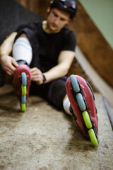 Blurred skater wearing colorful roller blades on ramp 
