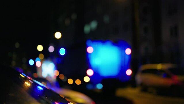 Defocused bokeh lights: Emergency crime scene with flashing siren at night