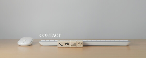 Website page, contact us or email marketing concept, customer support hotline, contact us. wooden cube with email, phone, address, chat message icon on computer keyboard - obrazy, fototapety, plakaty