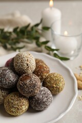 Different delicious vegan candy balls on light grey marble table