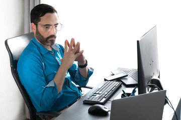 Middle-aged male home office. work online with. Fingertips joined