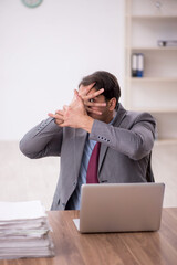 Young male employee working in the office