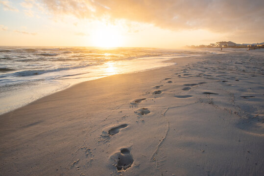 Footsteps on beach at sunsert
