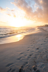 Fototapeta na wymiar Footsteps on beach at sunset