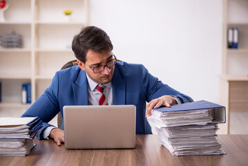 Young male employee working in the office