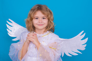 Child angel. Portrait of cute kid with angel wings isolated on studio background. Little angel, valentines day. Angelic kids.