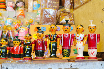 Wooden Indian dolls for sale in a souvenir shop in Tirupati, India.