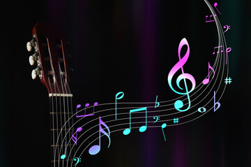 Staff with music notes and symbols flowing from acoustic guitar neck on dark background, closeup