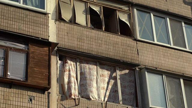 Consequences of rocket attack on the center of Ukraine. Funnel from a drone explosion. Attack of Iranian Shahed 136 drones on Kyiv. Damaged residential building. Broken windows and holes from debris. 