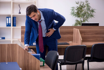 Young male employee working in the office