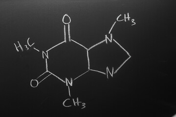 Caffeine formula drawn with chalk on blackboard. Coffee Concept.