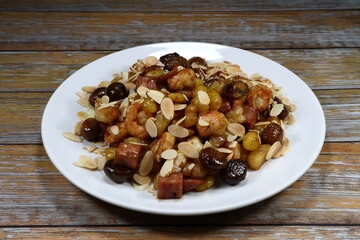 Pile of Stir and fried mixed Chinese fruits and gingko nuts serving on the plate. Famous ancient Chinese menu in restaurant. 