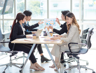 Fototapeta premium Millennial Asian young professional successful male female businessmen businesswomen employee in formal suit sitting smiling discussing communicating together in company office meeting room workplace