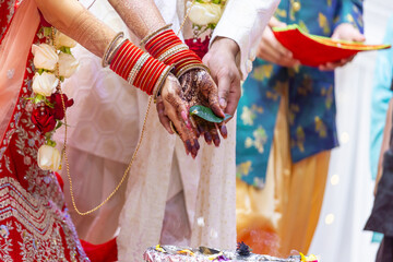 Fototapeta na wymiar Indian Hindu wedding ceremony pooja bride and groom's hands close up