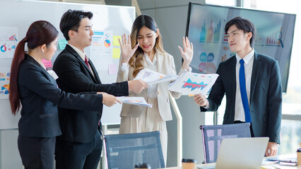 Millennial Asian young stressed upset businesswoman employee in formal suit denying graph chart strategy paperwork document reports from lazy male female colleagues in company office meeting room