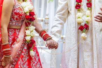 Indian Hindu wedding ceremony pooja bride and groom's hands close up