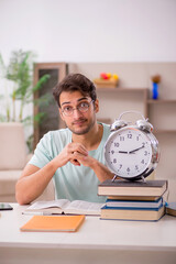Young male student preparing for exams at home