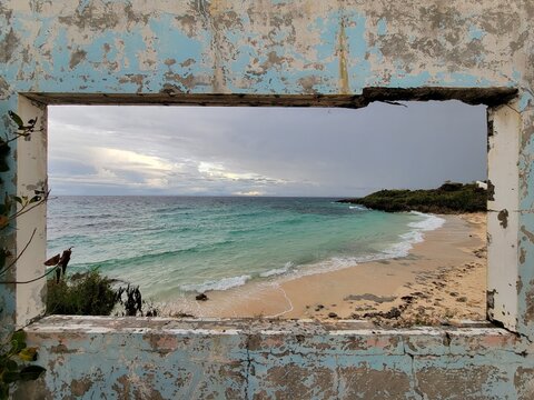 Fototapeta Beautiful sandy beach, as seen through an open window of an abandoned building - Malapascua Island, Philippines