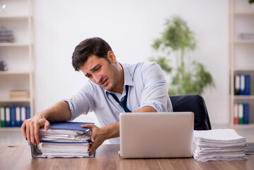 Young male employee working in the office