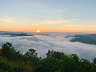 Beautiful sunrise on the Mekong River and mist at Phu Huay Isan, Nong Khai Province, Thailand