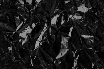 Shiny black grey foil metal texture, abstract wrapping paper for background and design art work.