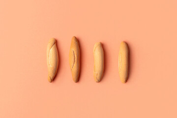 Flat lay of picos - four Spanish bread sticks on the beige background