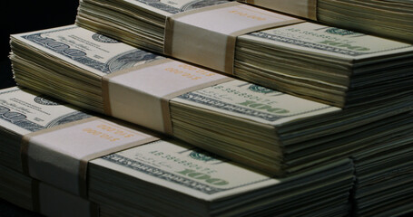 US one hundred dollars bills money line up pattern, close up. Stacks of Hundred Dollar Bills on a black background