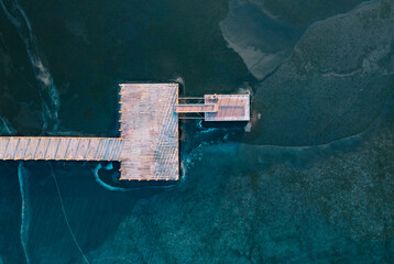 Aerial view of wooden trestle over frozen lake in winter