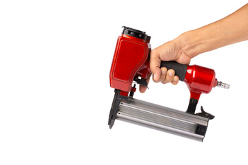 Man hand holding electric nail gun (pneumatic gun) isolated white background with clipping path. - obrazy, fototapety, plakaty