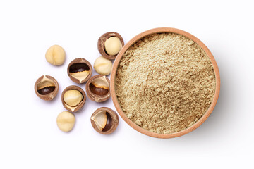 Macadamia nut powder in wooden bowl isolated on white background, top view, flat lay.