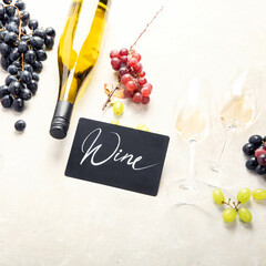Flat-lay of red and white wine in glasses and corkscrews over grey concrete background, top view,...