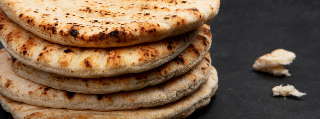 .Pita bread on dark background. Arabic, lebanese bread, traditional food.
