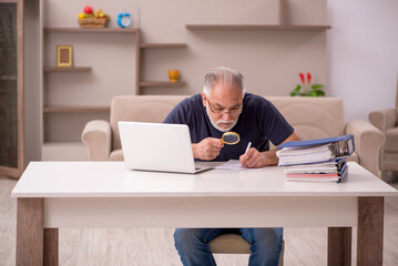 Fototapeta premium Old male employee working from home during pandemic