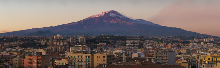 Snow covered Mount Etna volcano and Catania city center at sunset, from vantage point in Sicily, Italy © Em Campos
